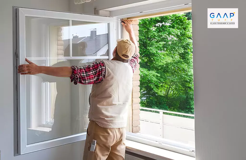 Person Installing a Glass Window Indoors